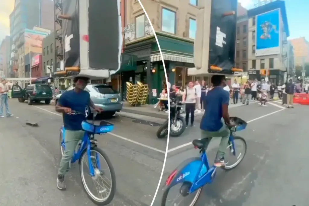 Stuntfietser balanceert bank op zijn hoofd in de drukte van New York
